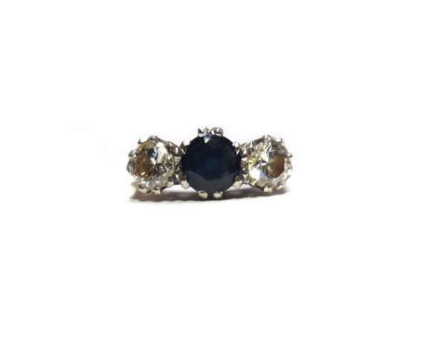 A gold, sapphire and diamond set three stone ring, mounted with a circular cut sapphire at the centre, between two circular c