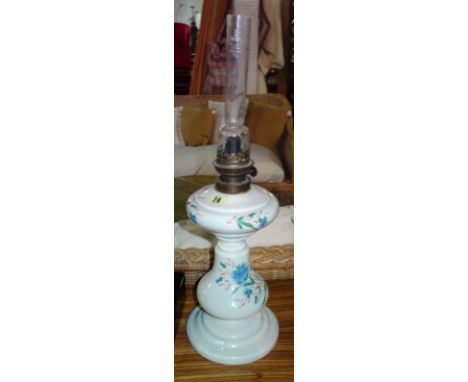 A Dutch ceramic oil lamp painted with a blue floral decoration, 59cm high.