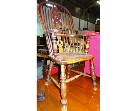 A 19th century ash and elm stick back Windsor open armchair.