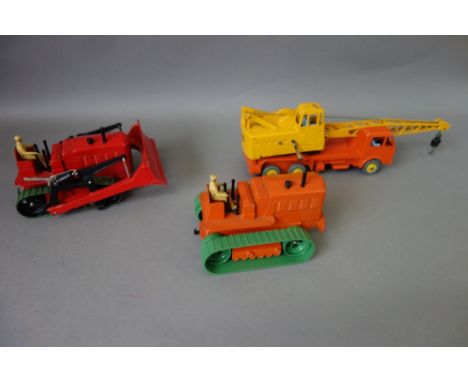 Three dinky commercial vehicles; 563 Heavy tractor, 972 20 tonne lorry mounted crane 'Coles' and 561 Blaw Knox bulldozer, all