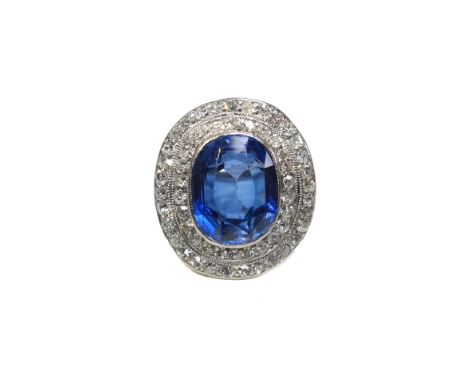 A synthetic sapphire and diamond set ring, collet set with the oval cut synthetic sapphire at the centre, within a two row su