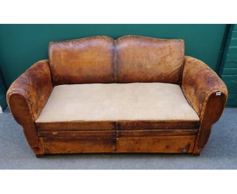 An early 20th century French brown lather upholstered sofa, with rollover arms and on block supports, 154cm wide x 86cm high.