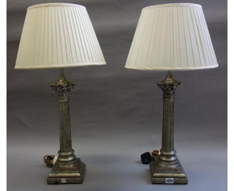 A pair of Victorian style gilt composite table lamps, modern, each of Corinthian column form, with cream silk pleated shades,