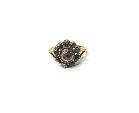 A gold and silver set rose diamond set cluster ring, mounted with the principal rose diamond at the centre, in a surround of 