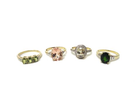 A gold, diamond and pale green gem set oval cluster ring and three 9ct gold, diamond and gem set rings, in a variety of desig