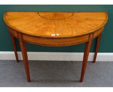 A George III and later satinwood, box and ebony strung demi-lune console table, the lunette and radial veneered top above pat