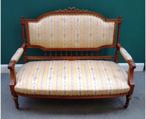 A late 19th century walnut show frame sofa, with ribbon carved crest and bow seat, on turned supports, 137cm wide x 108cm hig