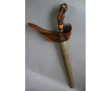 A Sumatran kris, with steel blade (35cm long), ornately carved wooden handle and a metal embossed wooden scabbard.