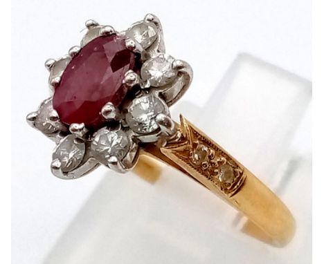 An 18 K yellow gold ring with an oval cut ruby surrounded by a halo of diamonds (0.40 carats). Ring size: J, weight: 3.4 g. 