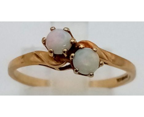 A 9 K yellow gold ring with a couple of opal cabochons. Ring size: Q, weight: 1.4 g. 