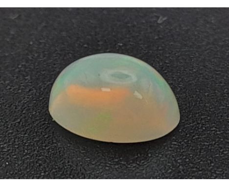 A fire opal cabochon (0.65 carats) with GLA certificate. Dimensions: 6.84 x 5.20 x 3.50 mm. Original valuation: $450 