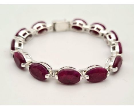 An Oval Shape Ruby Gemstone Bracelet in 925 Silver. 27g total weight. 19cm. 