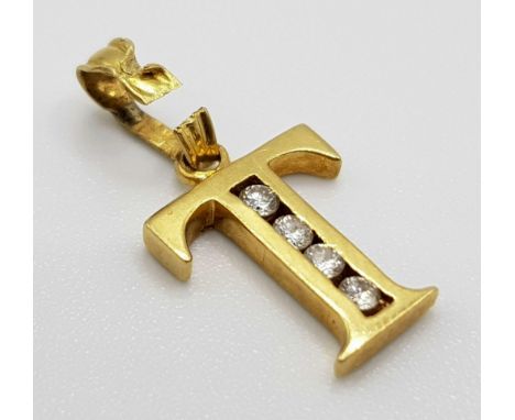 An 18 K yellow gold charm/pendant letter T. weight: 0.8 g. 