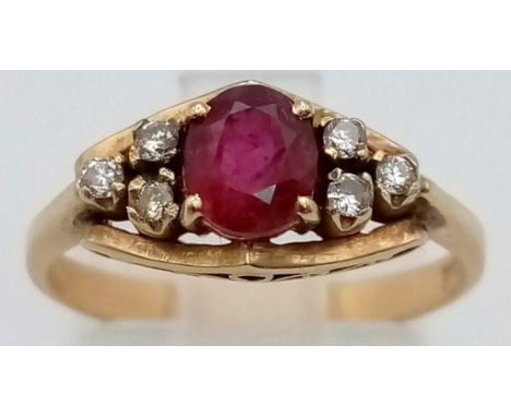 A 14K Yellow Gold Ruby and Diamond Ring. Central ruby with three diamonds on either shoulder. Size M. 2.61g. 