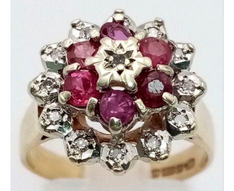 A 9K Yellow Gold Ruby and Diamond Floral Ring. Six rubies and thirteen diamonds. Size N. 4.16g total weight. 