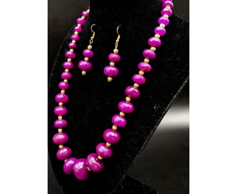 A quality, multi-faceted, graduating purple jade necklace and earrings set with gold filled spacer beads and clasp. Necklace 