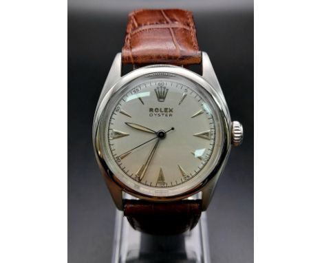 A Vintage Rolex Oyster Gents Watch. Brown leather strap. Stainless steel case - 35mm. White dial with arrow markers. Mechanic