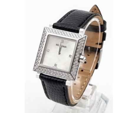 A Boucheron 18K Gold and Diamond Ladies Watch. Black leather strap. Gold and diamond rectangular case - 30 x 30mm. White dial