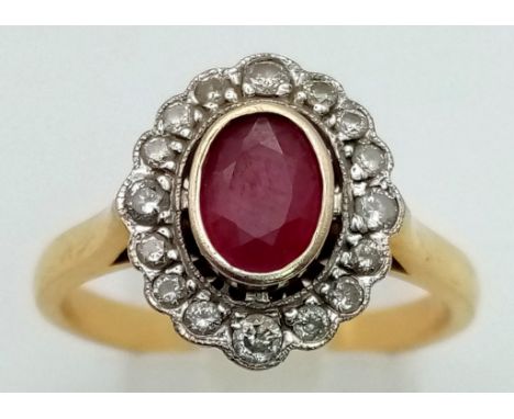 An 18 K yellow gold ring with an oval cut ruby surrounded by diamonds. Ring size: R, weight: 5.4 g. 