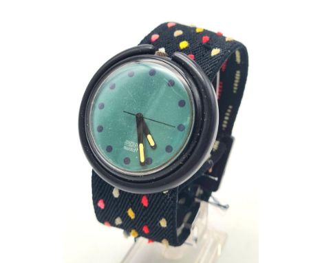 A Collectable Swatch Pop Watch. Multi-coloured cloth strap. Blue dial. Case -45mm. Quartz movement in working order. 