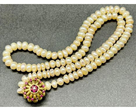 A Vintage Natural Pearl Rondelle Bead Necklace - With a 14k Yellow gold Ruby and Diamond Clasp. 43cm. 25.93g total weight. 