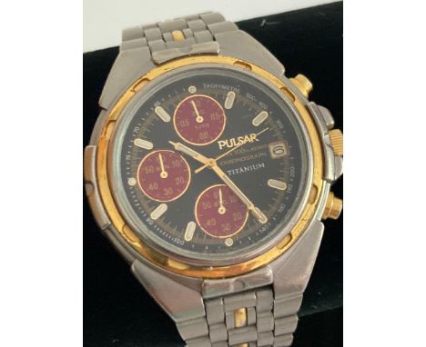 Gentlemans PULSAR TITANIUM CHRONOGRAPH in silver tone with dark grey face .Having multi burgundy subsidiary dials and golden 