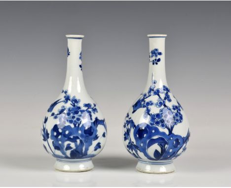 A pair of Chinese porcelain blue and white bottle vases possibly Kangxi period (1654-1722), painted with birds in flight amid