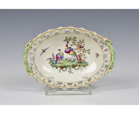 A Worcester First Period porcelain pierced oval basket c.1770, painted with exotic birds in a landscape, twin woven loop hand