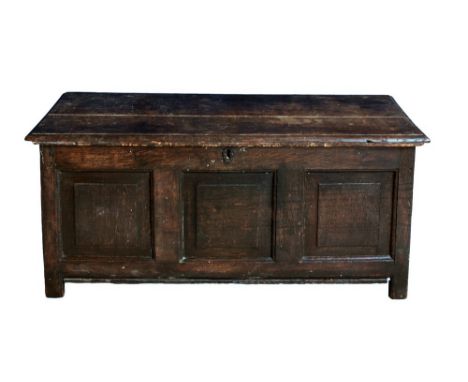 An early 18th century oak coffer the two plank moulded top on attractive iron strap hinges, over plain three panel front, rai