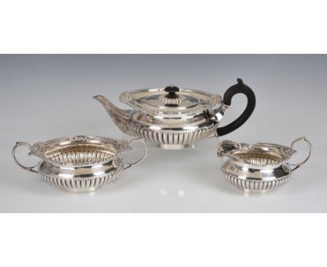 A good quality late Victorian silver three piece tea service Charles Stuart Harris, London, 1897, comprising of teapot, milk 