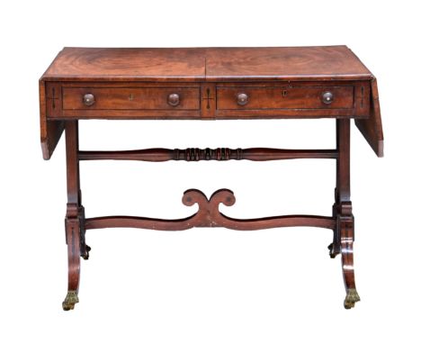 A George IV mahogany sofa table,&nbsp;the top with clipped corners, cross banded over two ebony strung drawers (one opening a