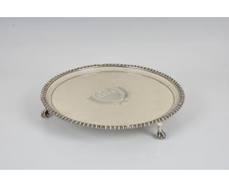 A George III silver salver / card waiter Edward Jay, London, 1791, of circular form with gadroon rim, the centre engraved wit
