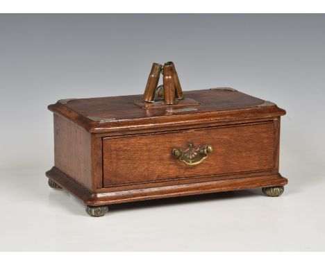 A late Victorian oak trench art style cigar box of rectangular form with single full length drawer, the top surmounted with t