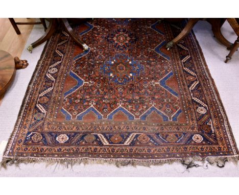 A Shiraz rug first half 20th century, with three light and dark blue medallions on an all over floral and foliate decorated f