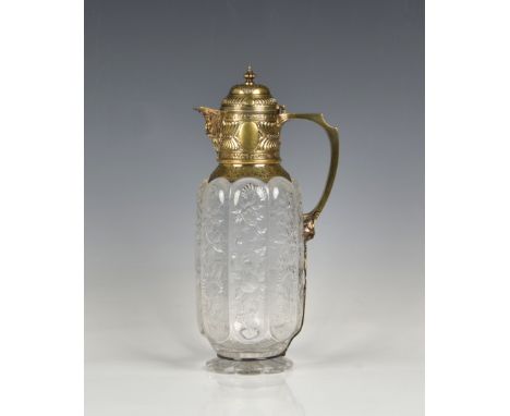 A fine Victorian silver gilt mounted 'rock crystal' cut glass claret jug Charles Edwards, London, 1883, of of octagonal lobbe