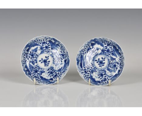 A pair of Chinese blue and white porcelain saucers 19th century, painted with alternate spoked panels of landscape and floral