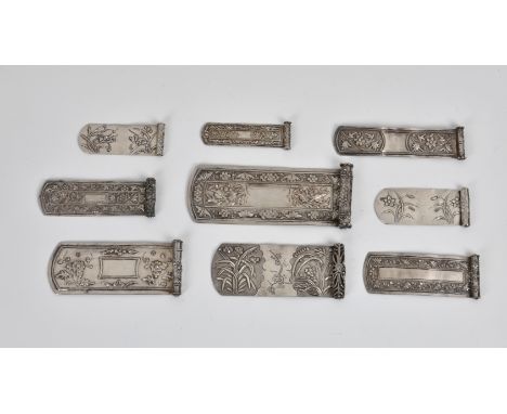 A collection of nine Chinese silver Bian Fang scroll-form hair ornaments Qing Dynasty, each repoussé decorated with flowers a