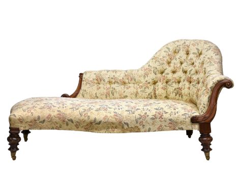 A Victorian mahogany button back chaise longue with floral fabric finish and 180.3 x 78.7cm.scroll carved arms, raised on tur