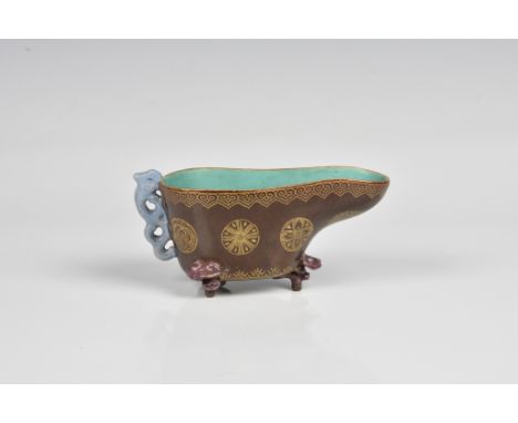 A Chinese 19th century brown glazed and gilt decorated libation cup with lavender glazed feet and light blue glazed beast han