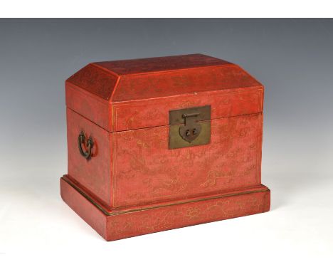 A Chinese red and gilt lacquer box 20th century, of rectangular form, decorated with five claw dragons, chasing flaming pearl