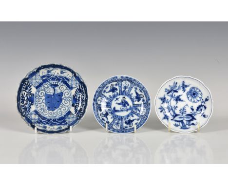 A Chinese Kangxi period scalloped saucer with lotus leaf &amp; scroll decoration four character mark within double concentric