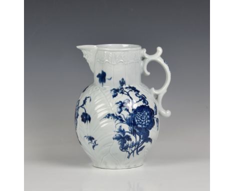 A large Worcester blue and white cabbage leaf moulded mask jug c. 1760, painted with the 'Heavy Naturalistic Floral' pattern,