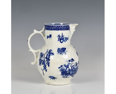 A first period Worcester leaf moulded mask jug blue and white printed with parrot pecking fruit on cabbage leaf moulded groun