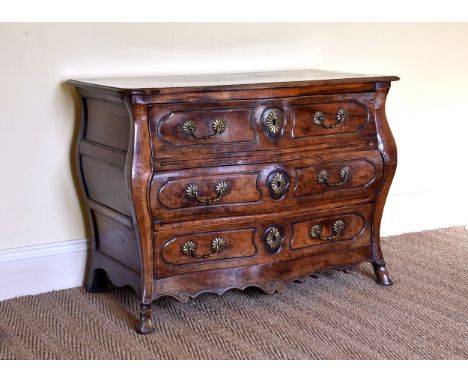 A good mid-18th century French provincial walnut three drawer bombe commode the cleated, moulded top over three panel sides, 