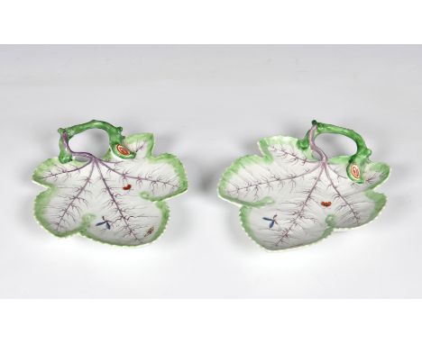 A pair of first period Worcester porcelain leaf dishes c.1760, of leaf shape with a naturalistically modelled twig loop handl
