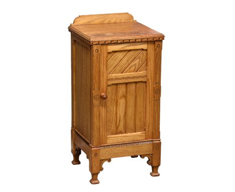 A 19th century Aesthetic Movement honey oak bedside cabinet the carved gallery over a rectangular top with inlaid frieze, a s