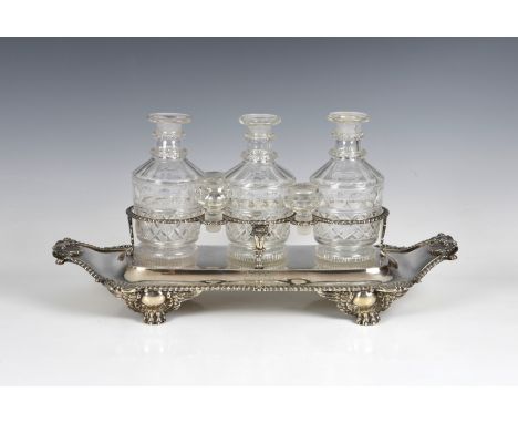 A good George III silver triple decanter stand William Kingdon, London 1812, of boat form with gadrooned, shell and foliate b