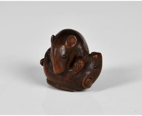 A Japanese carved boxwood netsuke of two rats locked in battle having good naturalistic textured fur and features with black 
