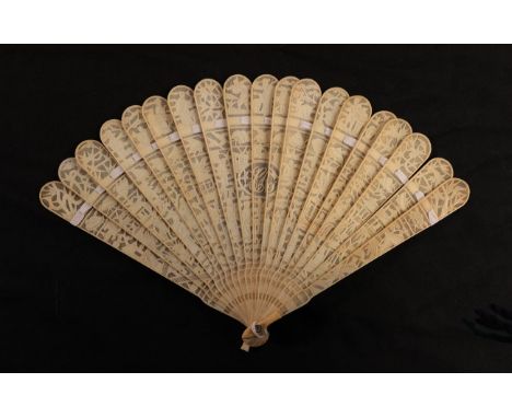 A circa 1840's Chinese carved ivory brisé fan, Qing Dynasty, the nineteen inner sticks well carved with a central oval contai