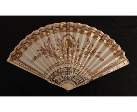 A Regency period ivory fan, with barrel head, the leaf, in cream silk, is embroidered in colourful sequins, with a deep top b